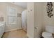 Simple bathroom with toilet and shower with peach-toned tile floor at 309 Foxpath Loop, Myrtle Beach, SC 29588