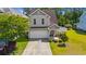 Charming two-story home with a well-manicured lawn, attached garage, and inviting front entrance at 309 Foxpath Loop, Myrtle Beach, SC 29588