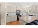 Well-lit kitchen with island seating, stainless appliances, and warm wood-toned floors at 309 Foxpath Loop, Myrtle Beach, SC 29588