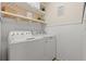 Efficient laundry room featuring a white washer, dryer, storage shelves and decorative laundry themed signage at 309 Foxpath Loop, Myrtle Beach, SC 29588