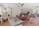 Open concept living area with hardwood floors, comfortable furniture, ceiling fan, and neutral tones at 309 Foxpath Loop, Myrtle Beach, SC 29588