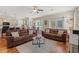 Spacious living room with hardwood floors, ceiling fan, and comfortable brown sofas and a dining area at 309 Foxpath Loop, Myrtle Beach, SC 29588