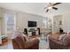 Bright and airy living room featuring wood floors, comfortable sofas, TV, and a ceiling fan at 309 Foxpath Loop, Myrtle Beach, SC 29588