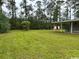 Spacious backyard with lush lawn, mature trees and storage shed at 321 Circle Heights Dr., Loris, SC 29569