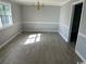 Bright dining room with wood-look floors and a vintage chandelier at 321 Circle Heights Dr., Loris, SC 29569