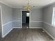 Neutral dining room featuring an ornate chandelier and wood-look floors at 321 Circle Heights Dr., Loris, SC 29569