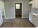 Efficient kitchen featuring white cabinets and wood-look flooring at 321 Circle Heights Dr., Loris, SC 29569