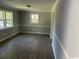 Spacious living room with new flooring, fresh paint, and large window that lets in light at 321 Circle Heights Dr., Loris, SC 29569