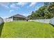A spacious backyard features lush green grass, a white fence and backs up to mature trees at 321 Sanctuary Ct., Myrtle Beach, SC 29588