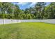 An expansive green backyard features a tall white fence for added privacy and backs up to mature trees at 321 Sanctuary Ct., Myrtle Beach, SC 29588