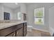 Bathroom featuring granite counters, a large mirror, and a garden window at 321 Sanctuary Ct., Myrtle Beach, SC 29588