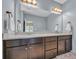 Bathroom with double sink vanity, granite countertops, and modern fixtures offers a spa-like retreat at 321 Sanctuary Ct., Myrtle Beach, SC 29588