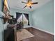 Well-lit bedroom featuring a ceiling fan, large window, and workstation area perfect for work from home setup at 321 Sanctuary Ct., Myrtle Beach, SC 29588