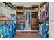 Walk-in closet provides ample storage with custom shelving, drawers, and hanging rods for organization at 321 Sanctuary Ct., Myrtle Beach, SC 29588