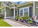 A charming home entrance features decorative plants and seasonal decor for added curb appeal at 321 Sanctuary Ct., Myrtle Beach, SC 29588