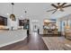 Open-concept living room with view of kitchen, white walls, and hardwood floors at 321 Sanctuary Ct., Myrtle Beach, SC 29588
