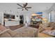 Open-concept living space with kitchen island, large TV, and comfortable leather furniture at 321 Sanctuary Ct., Myrtle Beach, SC 29588
