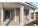 Inviting front porch with elegant white columns and a stylish blue door at 3558 Ashridge Way, Conway, SC 29526