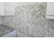 Close up of the beautiful herringbone tile backsplash with granite countertops in the kitchen area at 3619 Allentown Dr., Conway, SC 29526