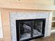Close-up of a fireplace with herringbone patterned tile and light wood trim at 3619 Allentown Dr., Conway, SC 29526