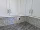 Close up of the white kitchen cabinets, granite countertops, and herringbone backsplash at 3619 Allentown Dr., Conway, SC 29526