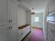 Laundry room features white cabinets, granite countertops, wood floor, and a window at 3619 Allentown Dr., Conway, SC 29526
