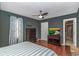 This cozy bedroom boasts hardwood floors, ceiling fan, and a TV for ultimate relaxation at 4018 Fairway Lakes Dr. # 4018, Myrtle Beach, SC 29577