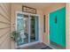 Inviting entryway featuring sliding glass door, bright teal door, and decorative accents at 4018 Fairway Lakes Dr. # 4018, Myrtle Beach, SC 29577