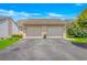 Two-car garage exterior with driveway, manicured lawn, flower pot and unit addresses at 4018 Fairway Lakes Dr. # 4018, Myrtle Beach, SC 29577