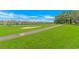 Expansive golf course view with beautiful waterfront homes in the distance, blending leisure with luxury at 4018 Fairway Lakes Dr. # 4018, Myrtle Beach, SC 29577