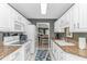 Galley kitchen with white appliances, white cabinetry, granite countertops, and golf course views at 4018 Fairway Lakes Dr. # 4018, Myrtle Beach, SC 29577