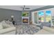 Cozy living room features a fireplace, ceiling fan, and view of the outdoor living space through sliding glass doors at 4018 Fairway Lakes Dr. # 4018, Myrtle Beach, SC 29577