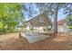 A large, white wooden carport sits in the backyard amongst the trees at 415 42Nd Ave. N, Myrtle Beach, SC 29577