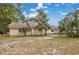Charming home with a tan exterior, palm trees, and blue sky in a serene setting at 415 42Nd Ave. N, Myrtle Beach, SC 29577