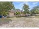 Side yard view of the home with mature trees, manicured lawn, and utility access at 415 42Nd Ave. N, Myrtle Beach, SC 29577