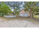Garage exterior featuring two doors, a white picket fence, and palm tree at 415 42Nd Ave. N, Myrtle Beach, SC 29577