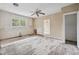 Partially renovated room featuring large windows, ceiling fan, and access to another room at 415 42Nd Ave. N, Myrtle Beach, SC 29577