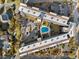 Aerial view of condo complex with swimming pool, parking, and mature landscaping at 423 Parker Dr. # 613, Pawleys Island, SC 29585