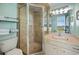 Bathroom featuring a glass-enclosed shower with tile surround and vanity with storage at 423 Parker Dr. # 613, Pawleys Island, SC 29585