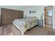 Bright bedroom with patterned bedding, wooden-style floors and a glimpse into the attached bathroom at 423 Parker Dr. # 613, Pawleys Island, SC 29585