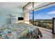 Bright bedroom featuring ocean views from large windows and a sliding glass door at 423 Parker Dr. # 613, Pawleys Island, SC 29585