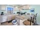 Bright kitchen featuring stainless steel appliances, granite countertops, and a breakfast bar at 423 Parker Dr. # 613, Pawleys Island, SC 29585