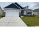 Charming single-story home with a two-car garage, well-manicured lawn, and welcoming curb appeal at 434 Lifestyle Court, Surfside Beach, SC 29575
