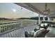 Relaxing covered back porch with wicker seating, ceiling fans, and waterfront marsh views at 4525 Landing Rd., Little River, SC 29566