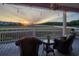 Relaxing back porch with comfortable seating and a view of the marsh and water at sunset at 4525 Landing Rd., Little River, SC 29566