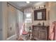 Elegant bathroom features a decorative vanity, a floral shower curtain, and a vanity with a window view at 4525 Landing Rd., Little River, SC 29566