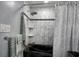 A modern bathroom with a black soaking tub, a rainfall shower head, and marble-look tile at 4525 Landing Rd., Little River, SC 29566