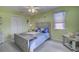 Bright bedroom featuring a full-sized bed, coastal decor, and a ceiling fan at 4525 Landing Rd., Little River, SC 29566