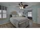 A bright bedroom with a queen-sized bed, ceiling fan, and a separate desk area at 4525 Landing Rd., Little River, SC 29566