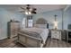 A cozy bedroom with a queen-sized bed, nightstands, ceiling fan, and coastal decor at 4525 Landing Rd., Little River, SC 29566